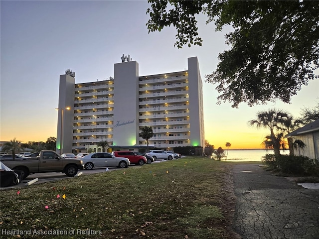 property at dusk with uncovered parking