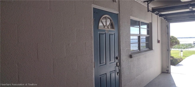 property entrance featuring stucco siding