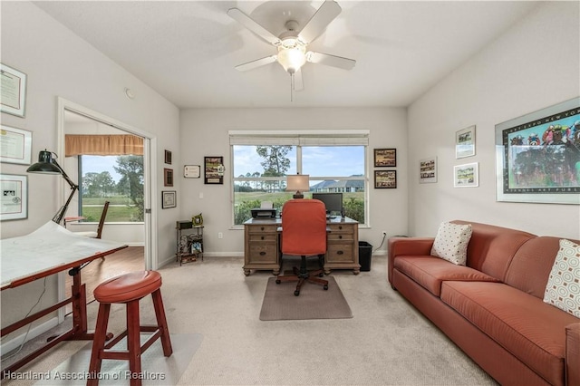 carpeted office space with ceiling fan