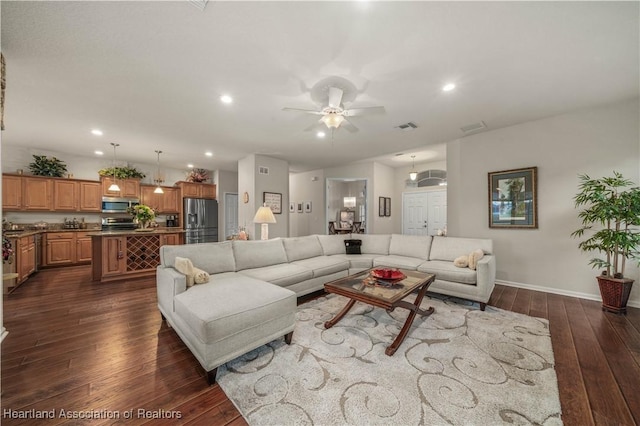 living room with ceiling fan and dark hardwood / wood-style flooring