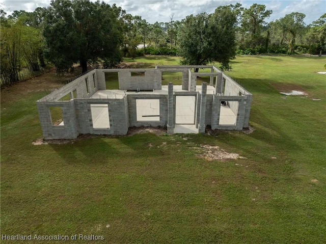 entry to storm shelter featuring a lawn