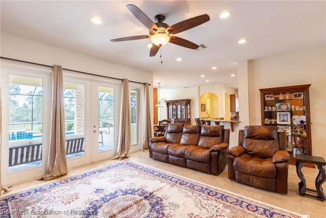 living room featuring ceiling fan, french doors, and light tile patterned floors