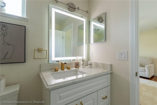 bathroom with vanity and toilet