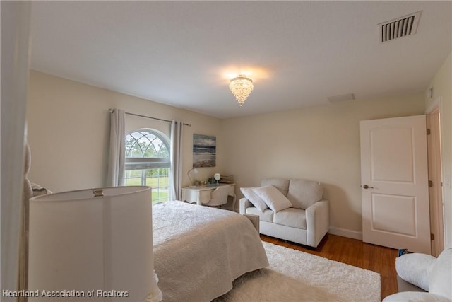 bedroom with hardwood / wood-style flooring