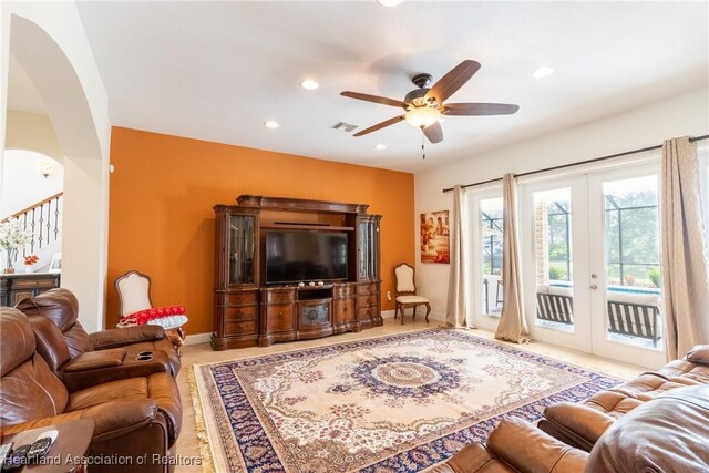 living room featuring ceiling fan and french doors