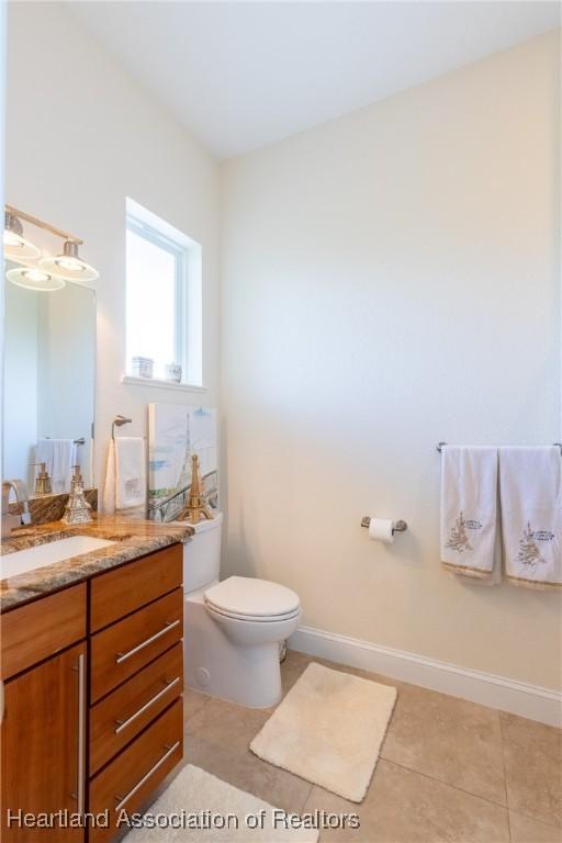 bathroom with tile patterned floors, vanity, and toilet