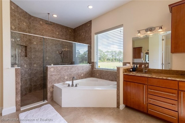 bathroom with tile patterned floors, vanity, and separate shower and tub