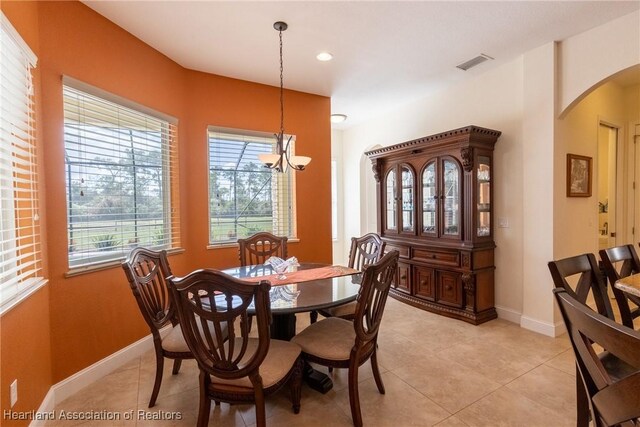 dining space featuring a notable chandelier and light tile patterned floors