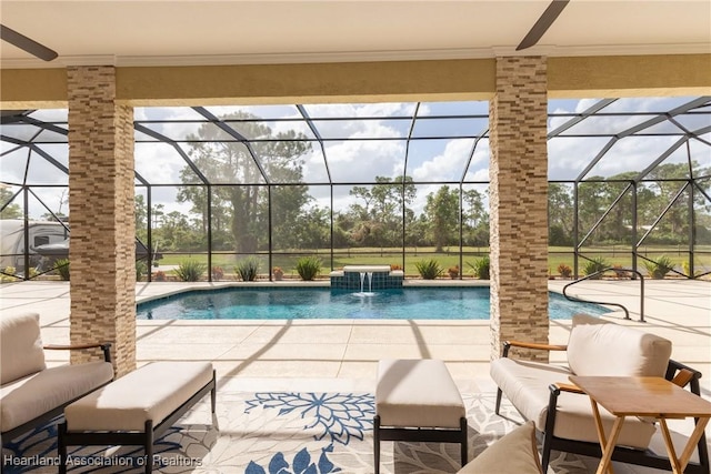 view of pool with a patio area, pool water feature, and glass enclosure