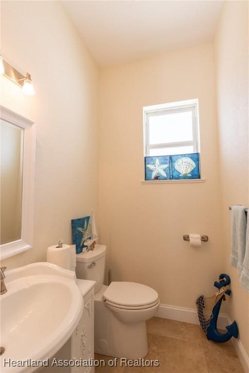 bathroom with tile patterned floors, toilet, and sink