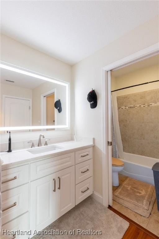 full bathroom with vanity, wood-type flooring, shower / bath combo, and toilet