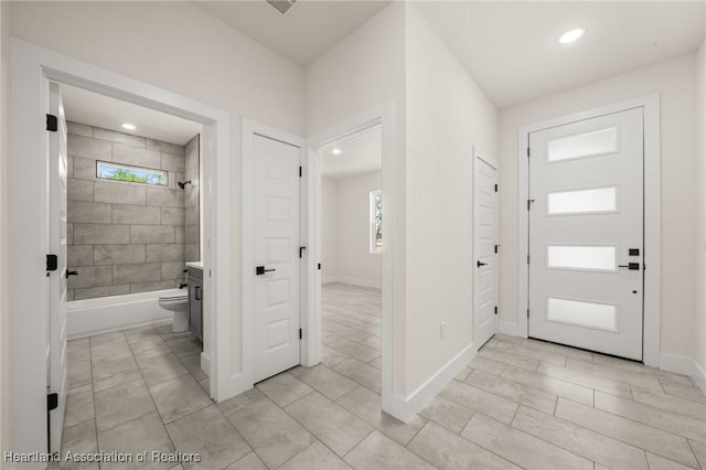 entrance foyer featuring healthy amount of natural light, recessed lighting, and baseboards