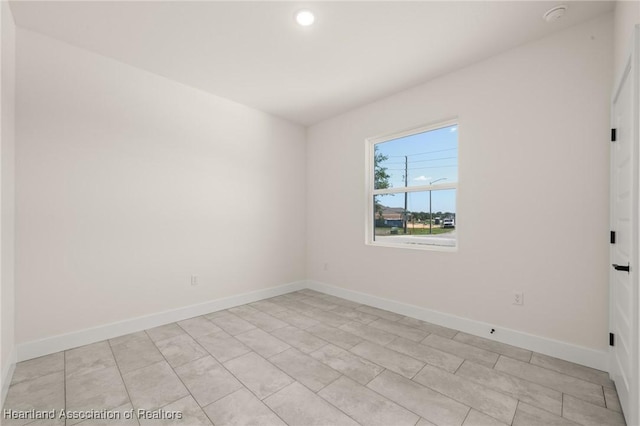 empty room with baseboards and recessed lighting