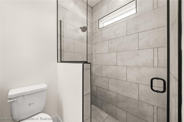 bathroom with tiled shower and toilet