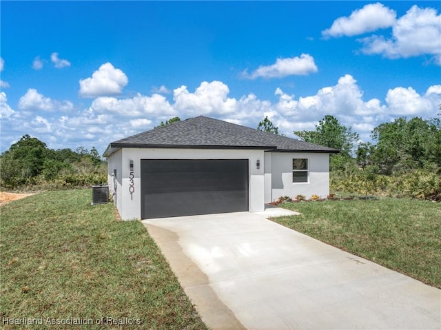 view of front facade with a garage, stucco siding, a front yard, central AC unit, and driveway
