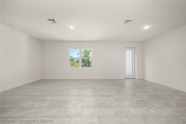 empty room with recessed lighting and baseboards