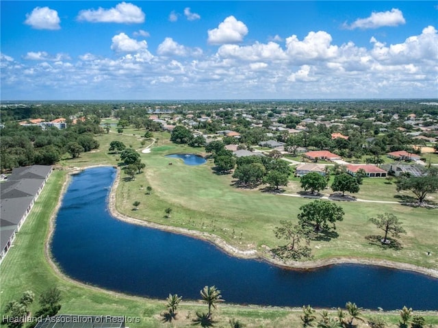 aerial view of residential area with a large body of water and a golf course