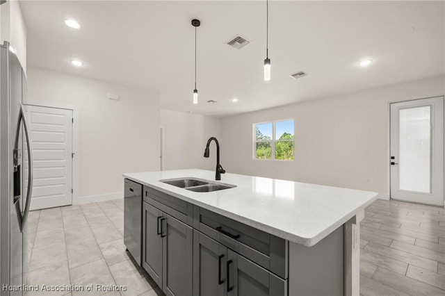 kitchen featuring a sink, appliances with stainless steel finishes, gray cabinets, pendant lighting, and recessed lighting