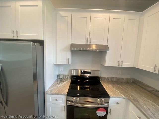 kitchen with white cabinets, light stone counters, and stainless steel appliances