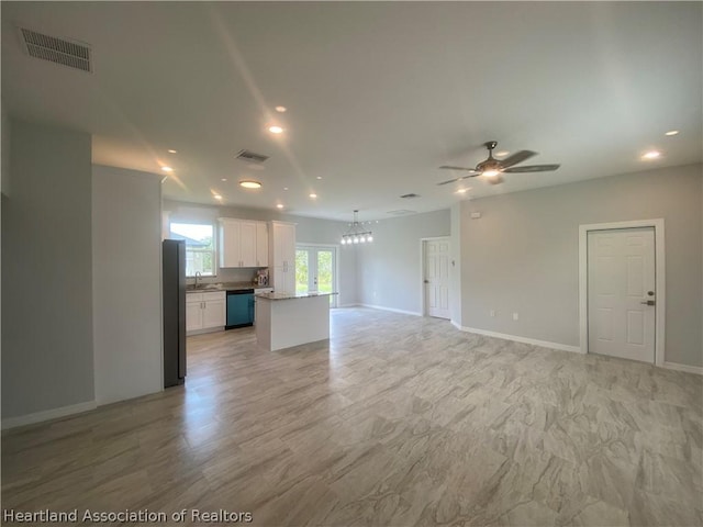 unfurnished living room with ceiling fan, sink, and french doors