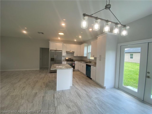 kitchen with appliances with stainless steel finishes, sink, decorative light fixtures, white cabinets, and a center island