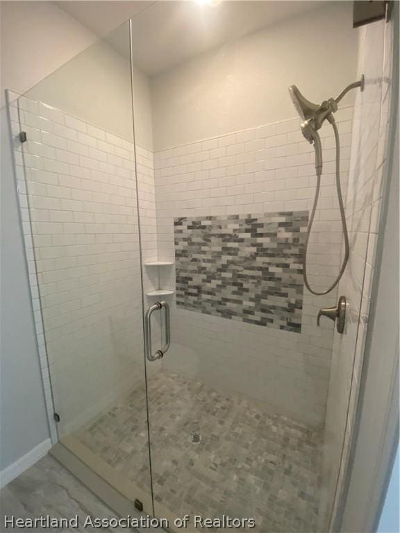 bathroom with a shower with shower door