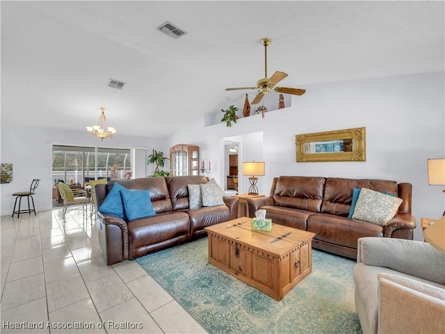 living room with ceiling fan with notable chandelier and high vaulted ceiling