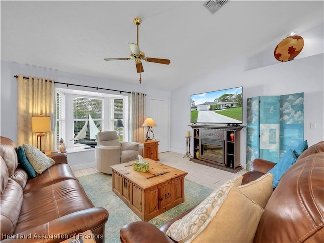 tiled living room with ceiling fan and vaulted ceiling