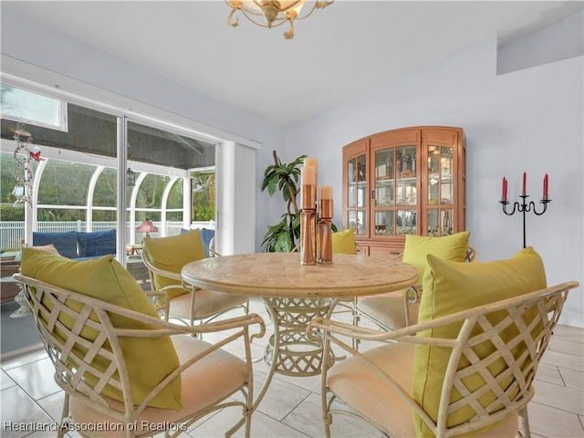 dining area with plenty of natural light and lofted ceiling