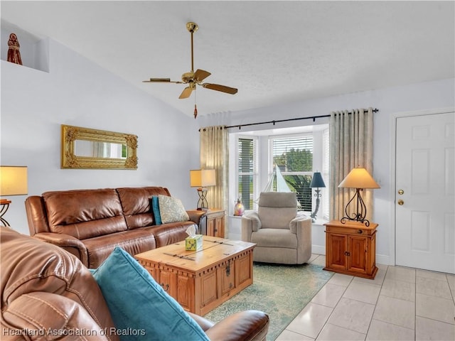 living room featuring vaulted ceiling, light tile patterned floors, and ceiling fan