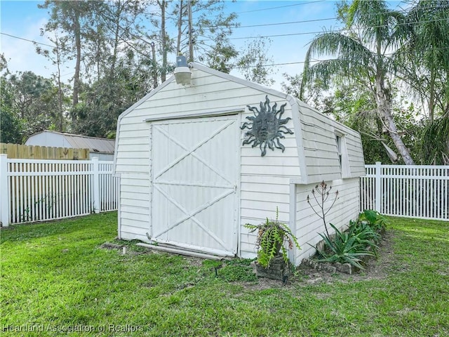 view of outdoor structure featuring a lawn