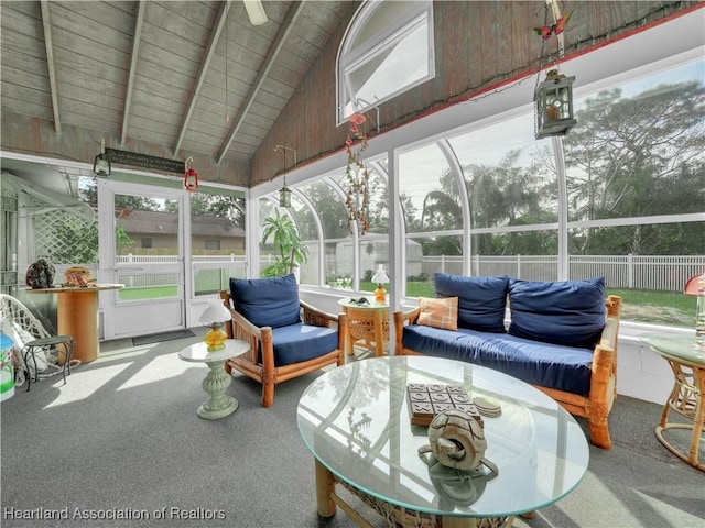 sunroom / solarium with vaulted ceiling with beams