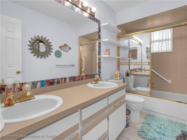 full bathroom featuring tile patterned flooring, vanity, enclosed tub / shower combo, and toilet