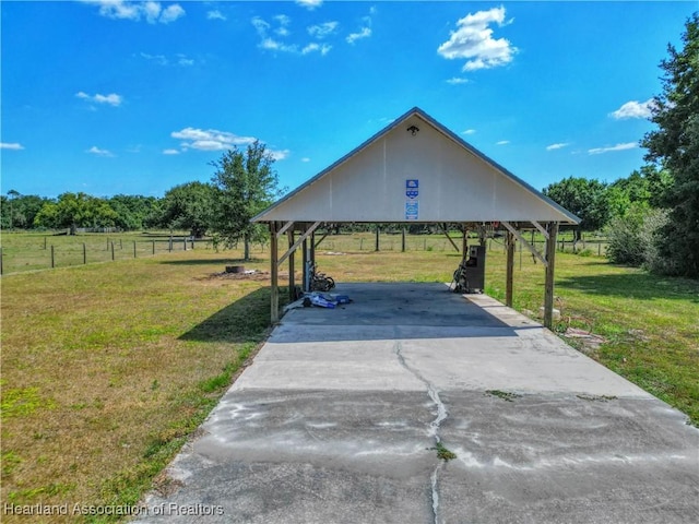 surrounding community with a carport, a yard, driveway, and fence