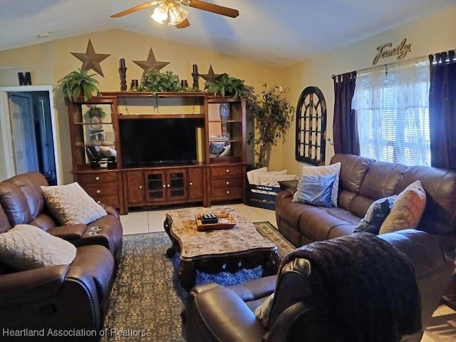 living area with a ceiling fan, light tile patterned floors, and lofted ceiling