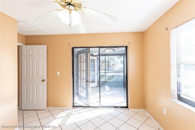 unfurnished room featuring light tile patterned flooring and ceiling fan