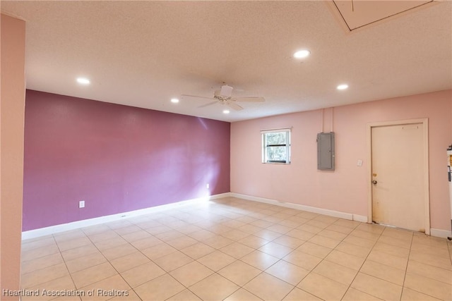 empty room with a textured ceiling, electric panel, and ceiling fan