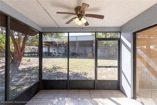 unfurnished sunroom featuring plenty of natural light and ceiling fan