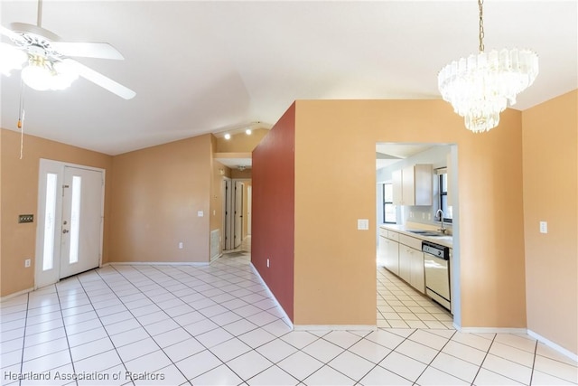 interior space with vaulted ceiling, sink, and ceiling fan with notable chandelier