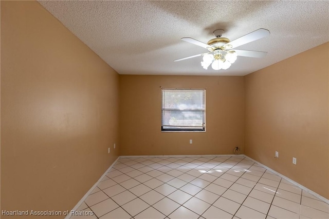 tiled spare room featuring ceiling fan and a textured ceiling