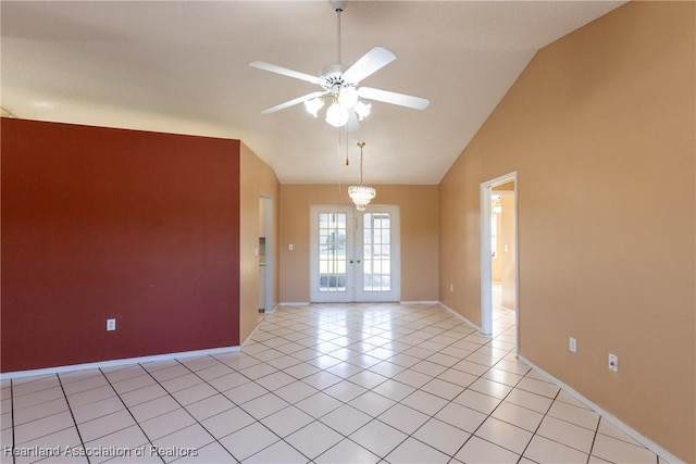 tiled empty room featuring french doors, ceiling fan, and vaulted ceiling