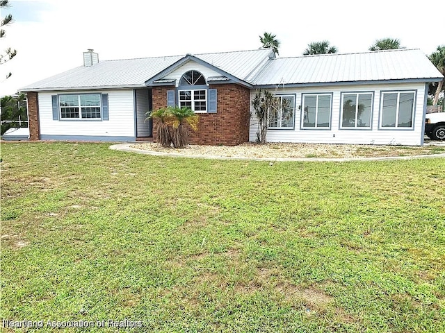 ranch-style home with a front lawn