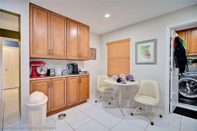 kitchen featuring light tile patterned floors and washer / dryer