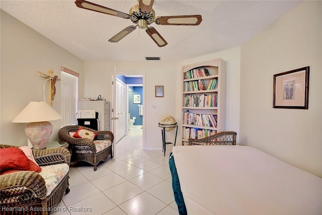 bedroom with light tile patterned floors, a textured ceiling, and ceiling fan