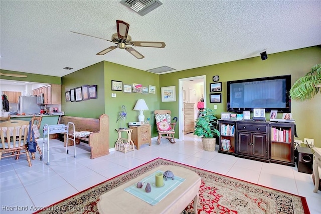 tiled living room featuring ceiling fan and a textured ceiling