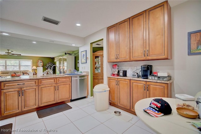 kitchen with sink, stainless steel dishwasher, ceiling fan, and light tile patterned floors