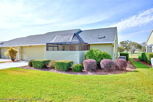 view of side of home with cooling unit, a garage, a lanai, and a lawn