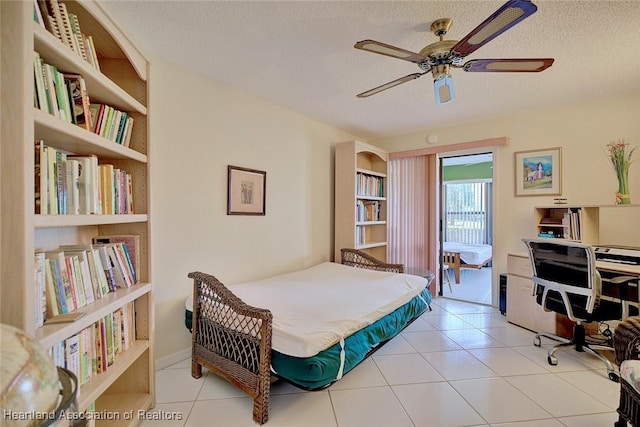 tiled bedroom with a textured ceiling and ceiling fan