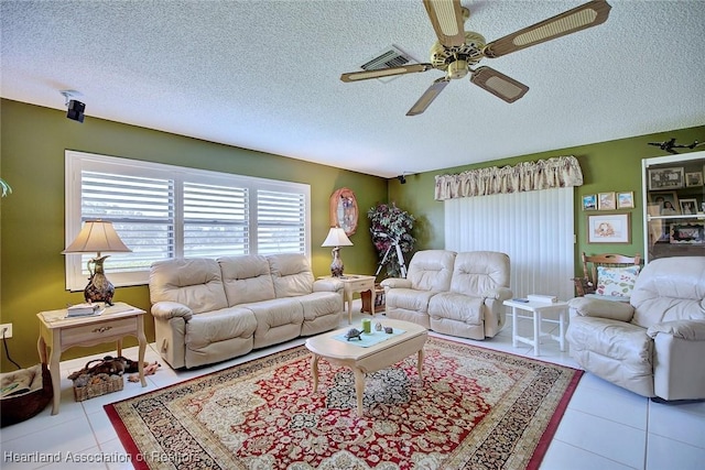 living room with light tile patterned floors, a textured ceiling, and ceiling fan