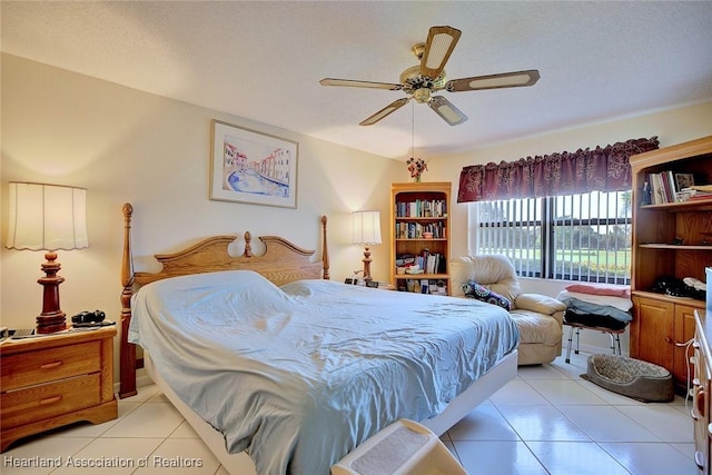 tiled bedroom featuring a textured ceiling and ceiling fan